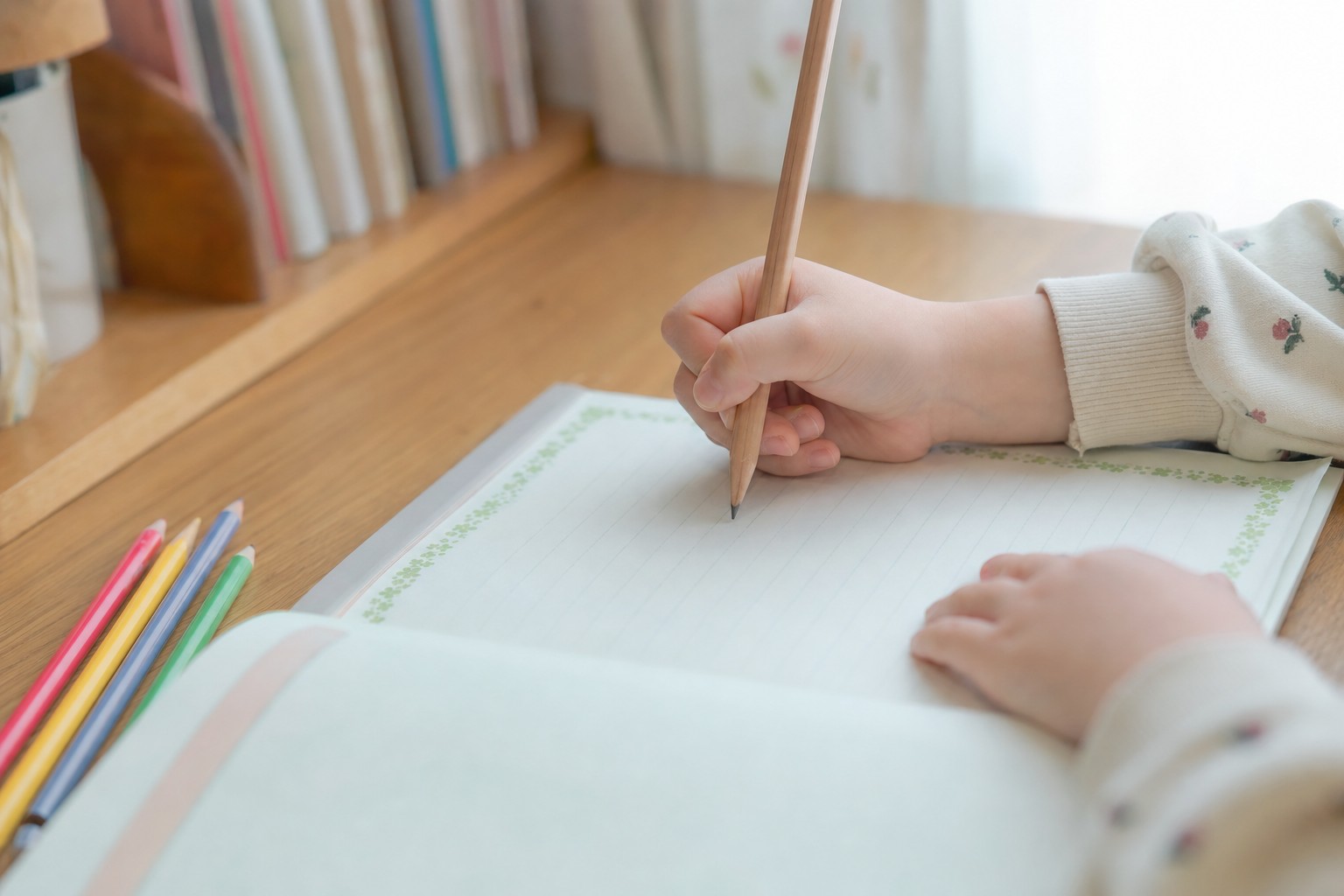 子どもが日記やノートに鉛筆で書く手元